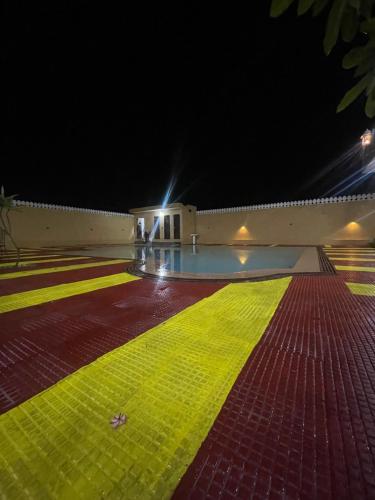 a building with a yellow stripe on the floor at night at L S Haveli in Pushkar