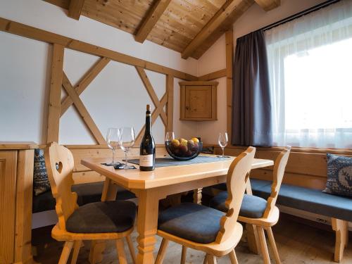 a dining room with a wooden table and chairs at Hotel Monte44 in Selva di Val Gardena