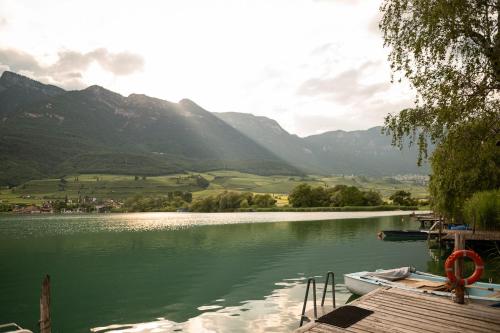 a view of a lake with a boat on a dock at Leuchtenburg am See in Caldaro