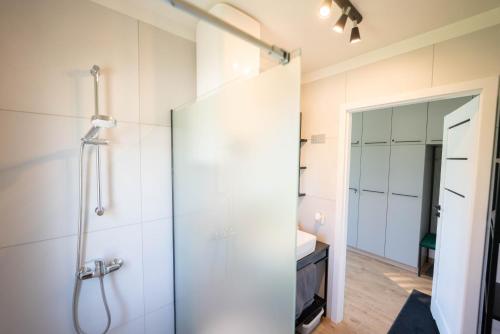 a bathroom with a shower with a glass door at Okno na Jurę in Kroczyce