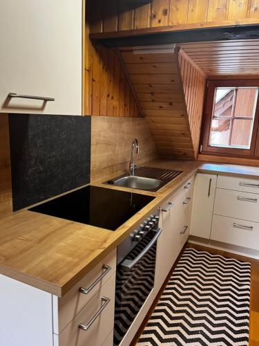 a kitchen with a sink and a counter at Ferienwohnungen am Pietschacherhof in Hochrindl