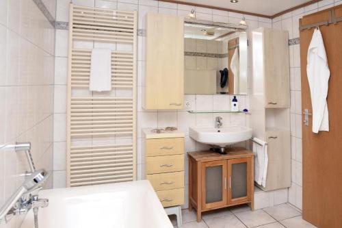 a small bathroom with a sink and a shower at Blaumeise in Bliesdorf
