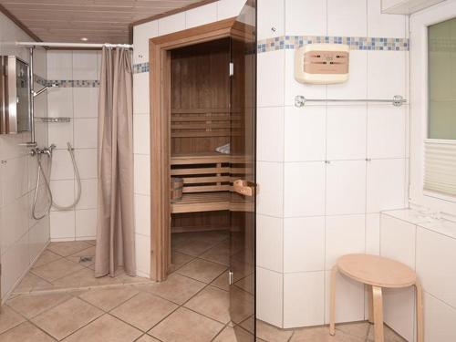 a bathroom with a shower and a toilet and a stool at Seeschwalbe in Bliesdorf
