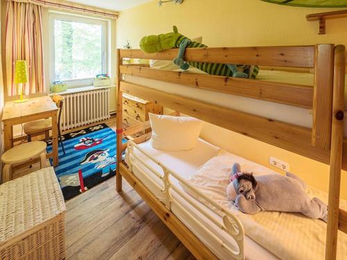 a bedroom with a bunk bed with a stuffed animal on it at Storchennest in Bliesdorf
