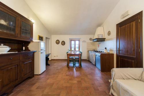 a kitchen with a refrigerator and a table in it at Agriturismo I Moricci in Peccioli