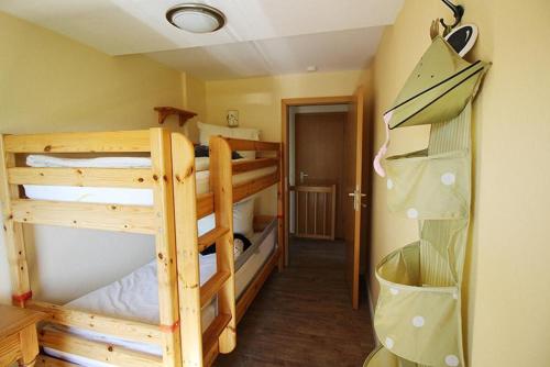 a room with three bunk beds and a closet at Seestern in Bliesdorf