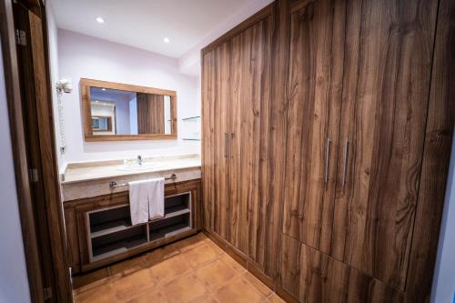 a bathroom with a sink and a large wooden wall at Be Live Collection Saïdia in Saidia 