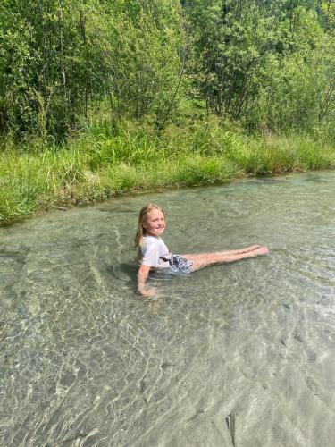 a little girl laying on her back in the water at Apartment Haus Christina in Großkirchheim