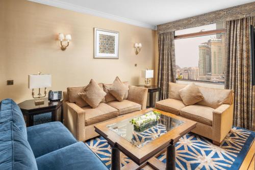 a living room with a couch and a table at Anjum Makkah Hotel in Makkah