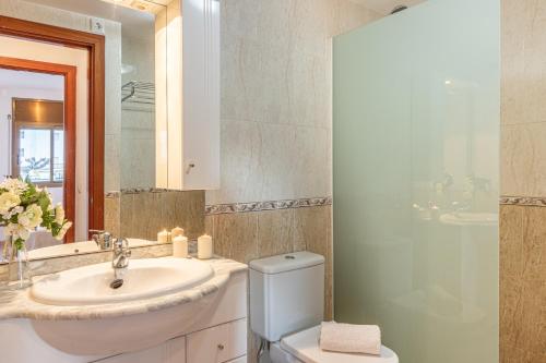 y baño con lavabo, aseo y espejo. en 161-Apartamento con vistas al mar a 100 m de la playa y en el centro de Empuriabrava-Empurialola, en Empuriabrava
