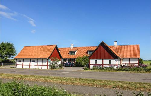 a row of houses with orange roofs on a road at Nice Apartment In Nexø With Kitchen in Neksø