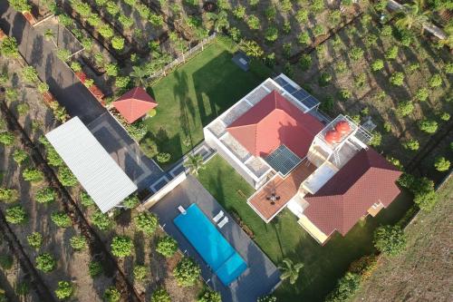 an overhead view of a house with a red roof at Lakeside Summers by VEO - Part of StayVista in Trimbak