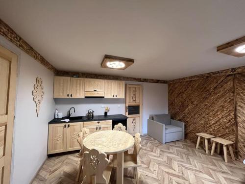 a kitchen with a table and chairs in a room at Apartament u Bafiów in Chochołów