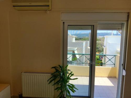 a sliding glass door with a view of a balcony at orange in Ialyssos