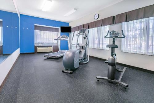 a gym with treadmills and machines in a room at Microtel Inn & Suites by Wyndham Austin Airport in Austin