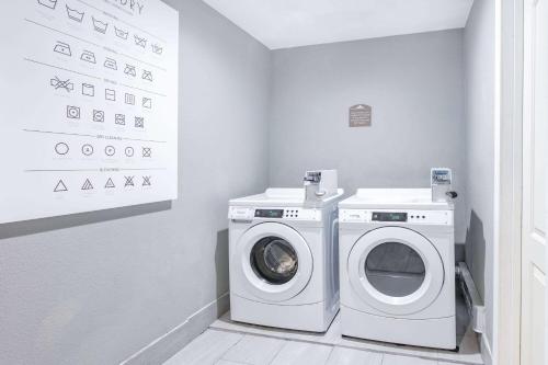 a laundry room with a washer and dryer in it at Microtel Inn & Suites by Wyndham Austin Airport in Austin