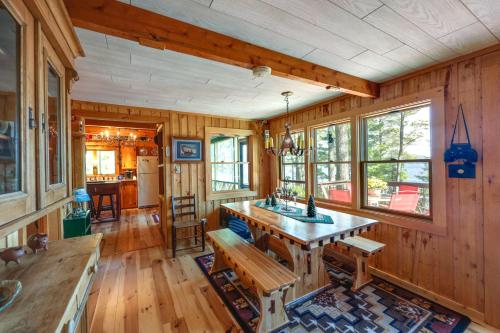 a kitchen with a wooden table and benches in a room at Waterfront Maine Vacation Rental with Private Dock in Orono