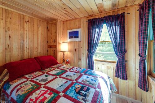a bedroom with a bed and a window at Waterfront Maine Vacation Rental with Private Dock in Orono
