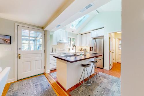 a kitchen with a sink and a counter with stools at Town of Rehoboth Beach 44 Henlopen Ave in Rehoboth Beach