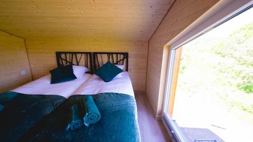 two beds in a small room with a window at Okno na Jurę in Kroczyce