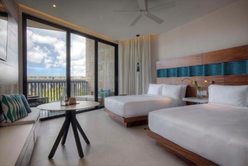 a hotel room with two beds and a balcony at Grand Hyatt Playa del Carmen Resort in Playa del Carmen