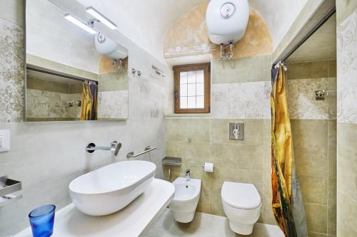 a bathroom with a sink and a toilet at Centro Storico Rooms in Gallipoli