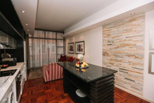 a kitchen with a island in the middle of a room at Mandela Rhodes Place in Cape Town