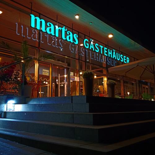 a restaurant with a staircase in front of a building at martas Gästehäuser Hauptbahnhof Berlin in Berlin