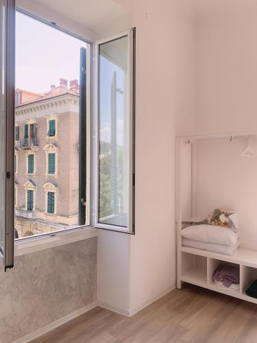 a white room with a large window at Brin home in La Spezia