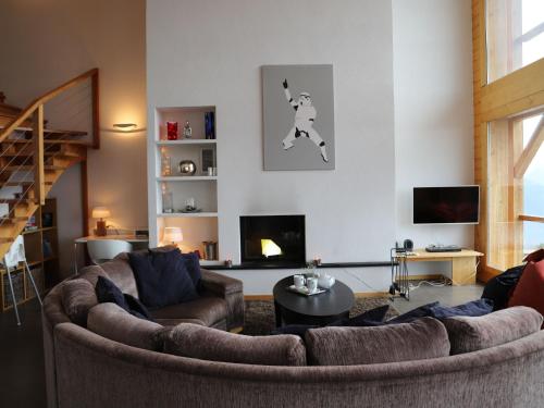 a living room with two couches and a fireplace at Apartment La Corniche 2 by Interhome in Nendaz