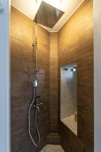a bathroom with a shower with wooden walls at Blue Horizon Syrma in Klima