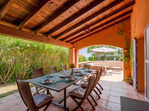 an outdoor dining room with a table and chairs at Holiday Home La Bastide Rose by Interhome in Sainte-Maxime