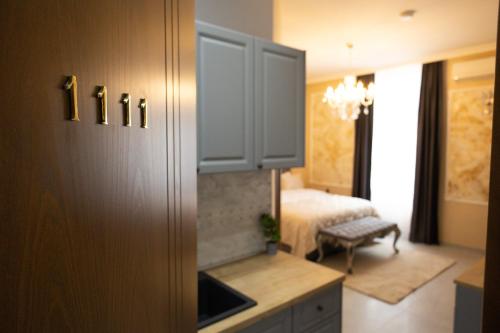 a room with a room with a bed and a kitchen at All Elevens 11 Apartments in Bitola