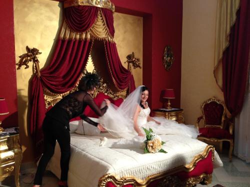 a man and a woman in a bed at La Dolce Vita - Luxury House in Agrigento
