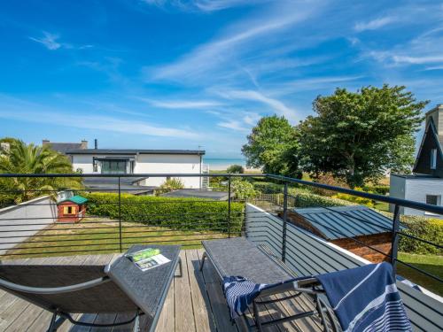 a balcony with a bench and a table and a view of the ocean at Holiday Home Les Dunes by Interhome in Plounéour-Trez