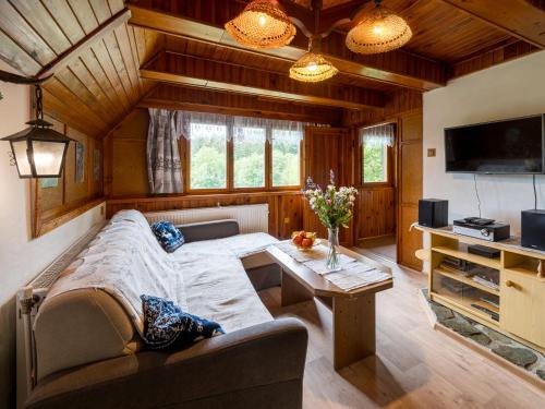 a living room with a couch and a table at Chalet Mrklov by Interhome in Mrklov