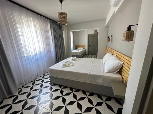 a bedroom with a bed and a bathroom at Arcadia Butik Otel in Canakkale