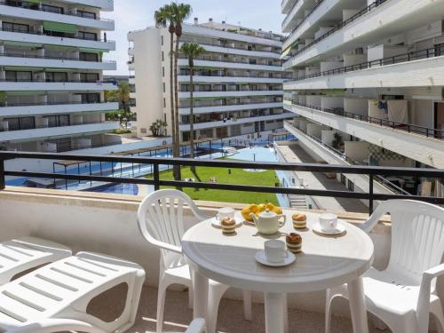 een witte tafel en stoelen op het balkon van een gebouw bij Apartment Riviera Park-4 by Interhome in Salou