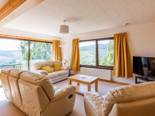 a living room with two couches and a tv at Holiday Home Achmony Type 2-2 by Interhome in Drumnadrochit