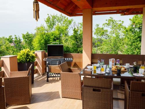an outdoor patio with a table and chairs and a grill at Apartment Zen by Interhome in Révfülöp