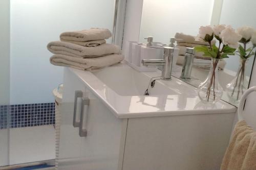 a bathroom with a sink and a mirror and towels at Old town Marbella home in Marbella