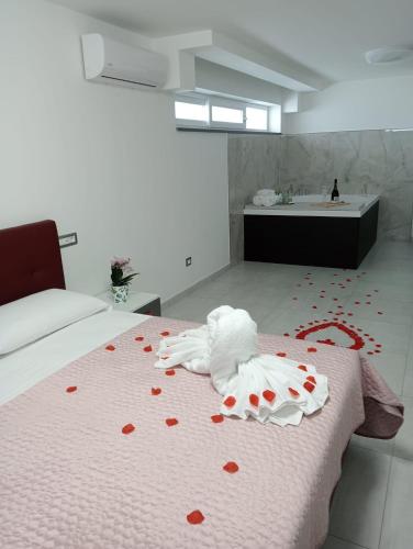 a room with a bed with red hearts on the floor at Rosy's House in Scafati