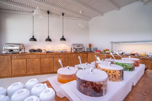 a kitchen with a bunch of food on tables at Aloe Hotel - Adults Only in Faliraki