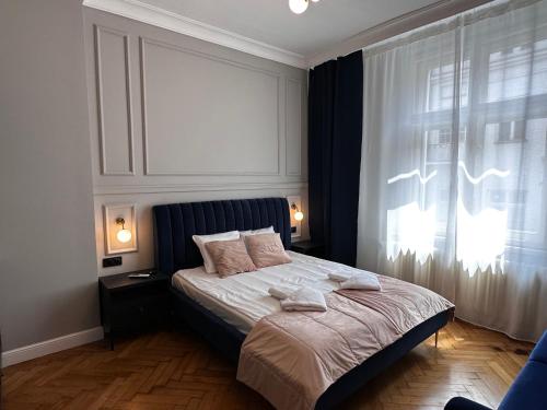a bedroom with a large bed with a window at Premium Apartment in Spiski Palace in Krakow