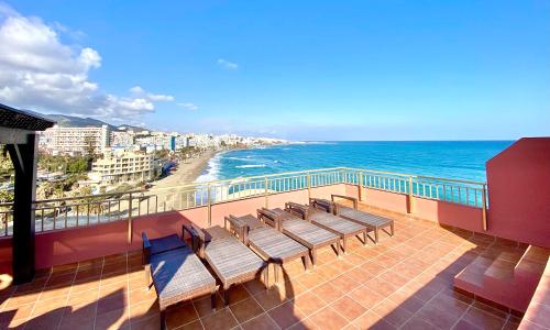 a group of benches sitting on a balcony overlooking the ocean at 2 bedroom Penthouse Sea View Apartment within Sunset Beach Club in Benalmadena Costa