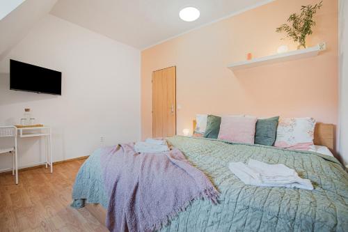 a bedroom with a bed with a blue comforter at Penzion Village Peace #29 by Goodnite cz - U Libušky in Brno
