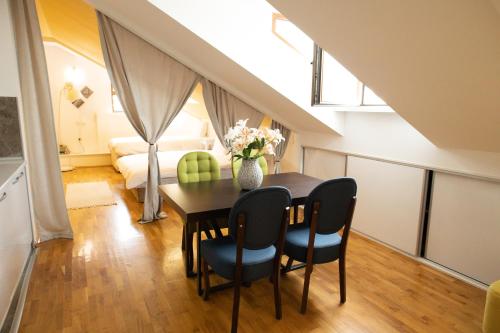 a dining room with a table and chairs and a bedroom at All Elevens 11 Apartments in Bitola