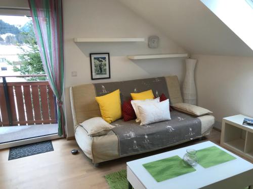 a living room with a couch and a balcony at ARLALPIN in Pettneu am Arlberg