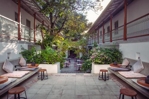 a courtyard of a building with chairs and plants at Fort Bazaar in Galle