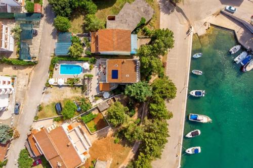 an aerial view of a house next to the water at House Dinka with Pool in Porat